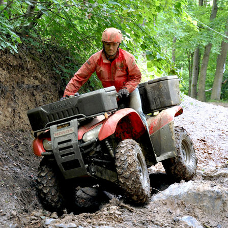 Fourtrax 420 being used by model, forest location.