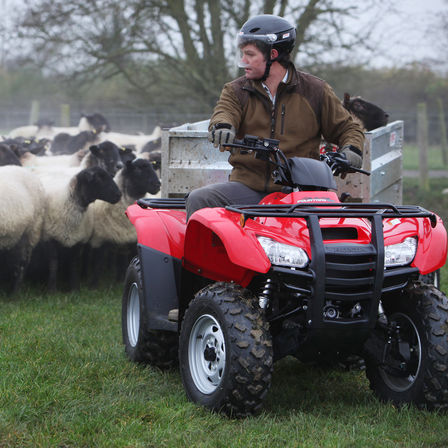 Fourtrax 420 being used by model, field location.