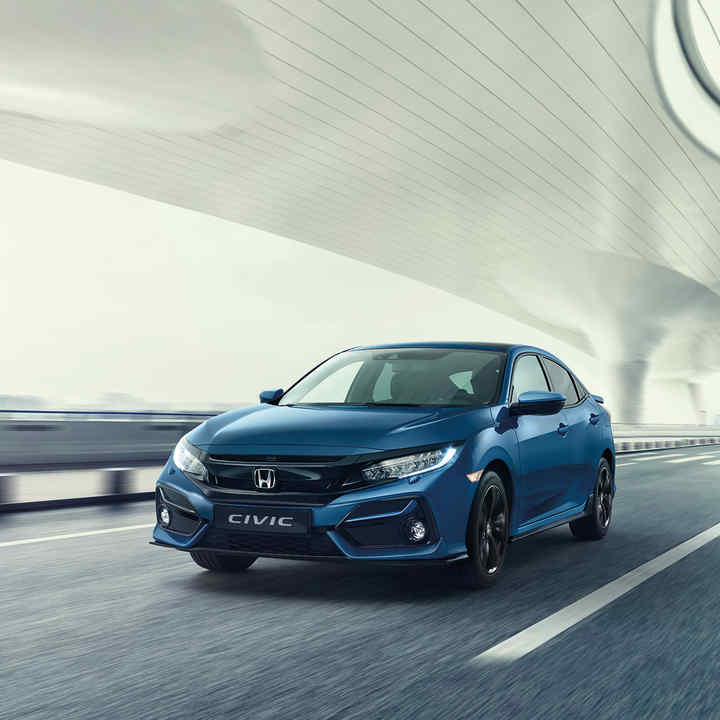 Three quarters front view under a bridge.