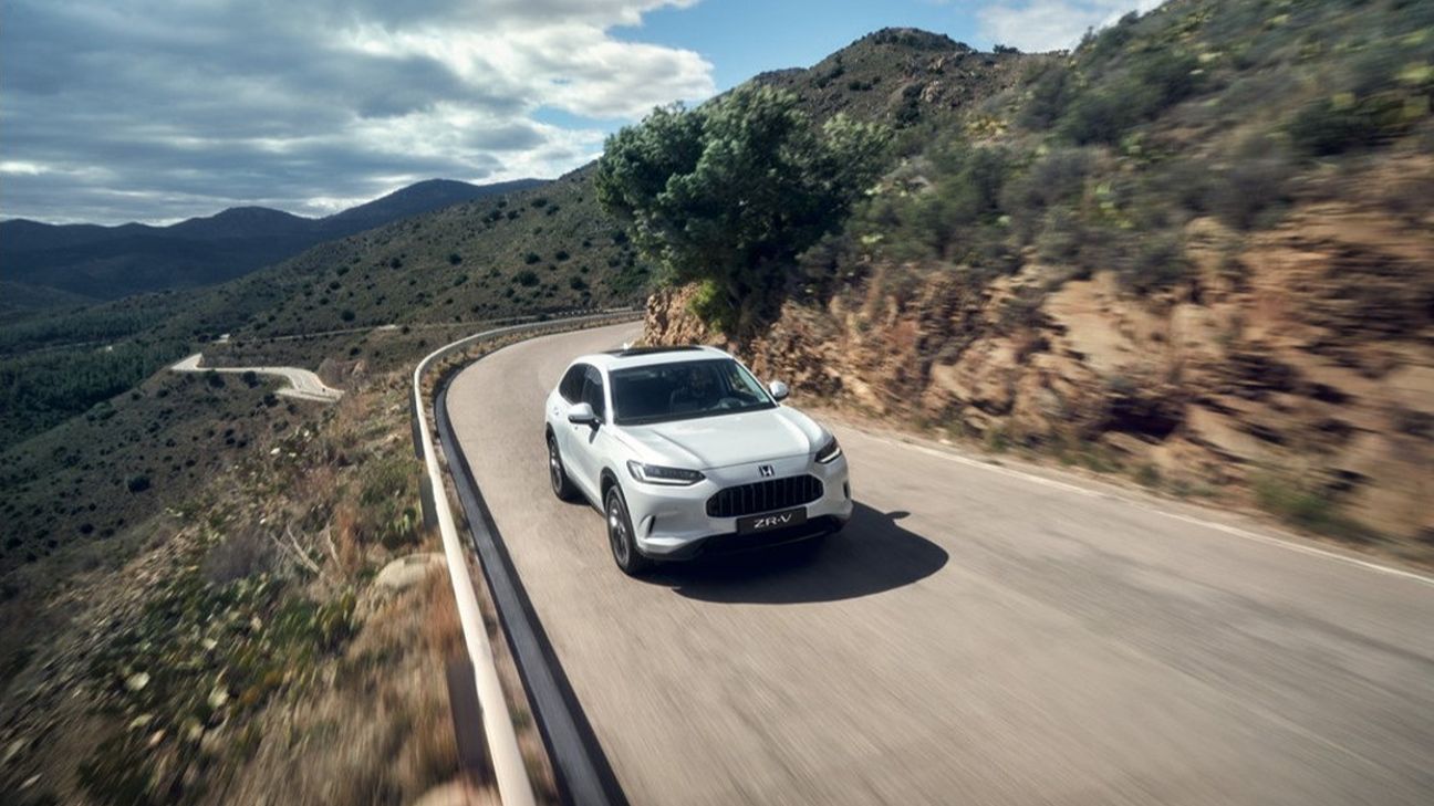 a white Honda car on the road