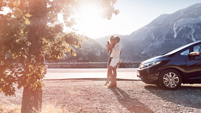 Shot of two women looking at a phone on roadside