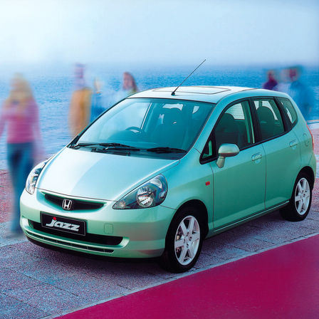 Front three-quarter facing Honda Jazz, seaside location.