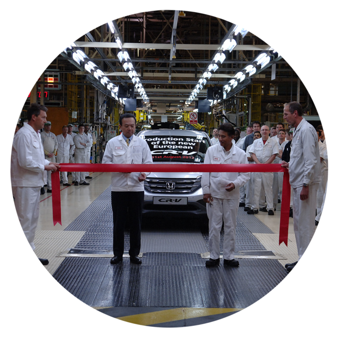 Front facing Honda CR-V with factory workers.