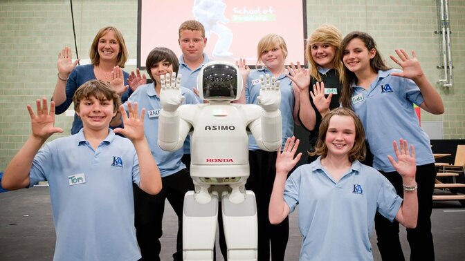 Asimo and pupils at Honda's School of Dreams.