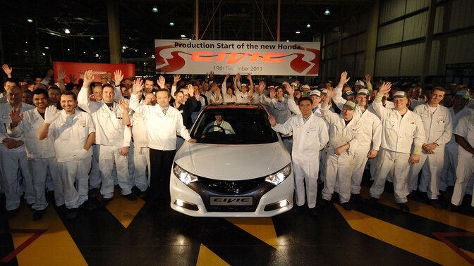 Front facing Honda Civic 5 door with workers.