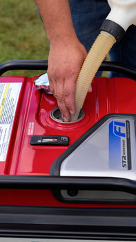 EU70is generator being refueled by model, exterior setting.