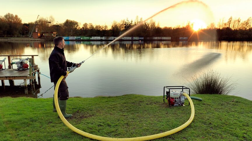 High pressure water pump, being used by model, lake location.