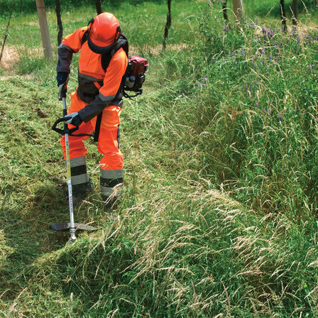 Honda Backpack Brushcutters, being used by model, grassland location.