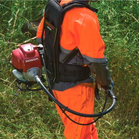 Honda Backpack Brushcutters, being used by model, focusing on the part-flexible shaft.
