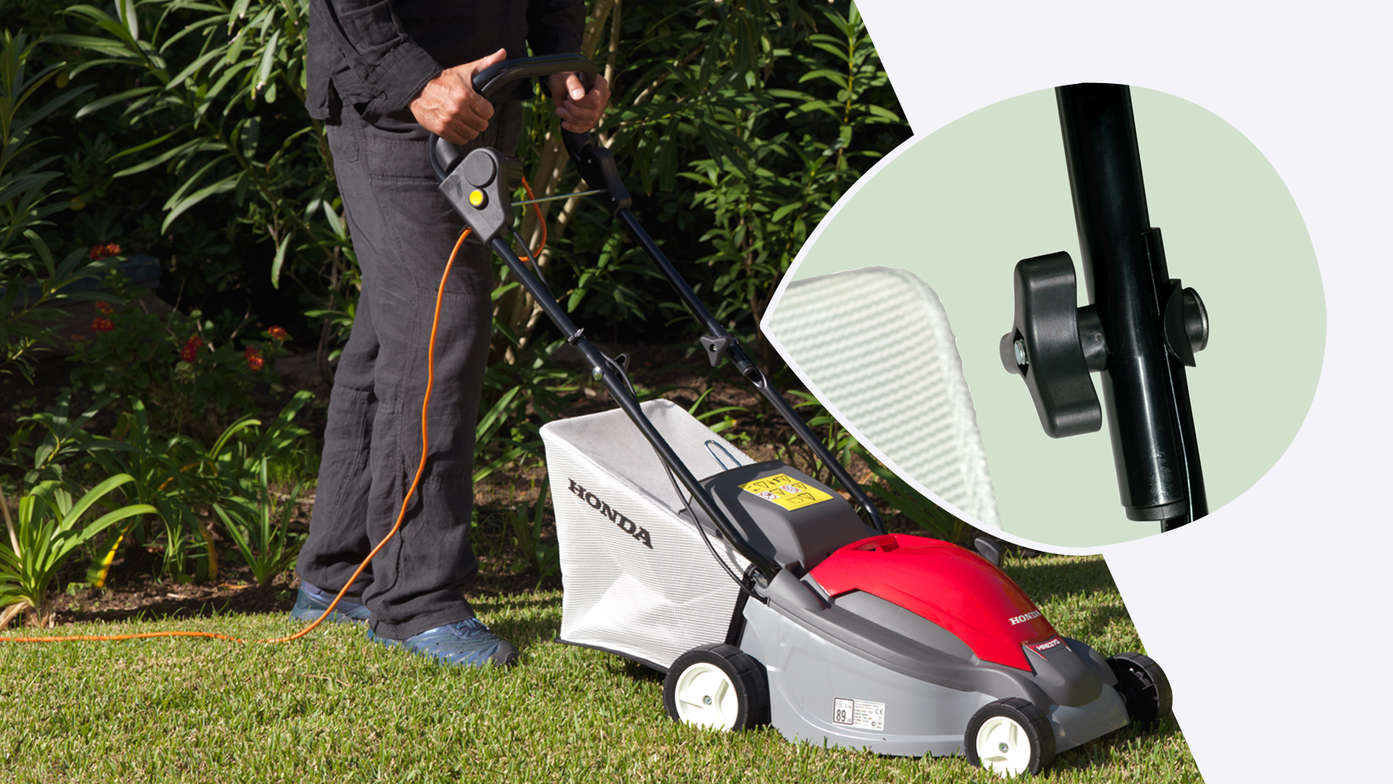 Honda HRE lawnmower, front-threequarter view, right facing, garden location. Close up of fold away handles.