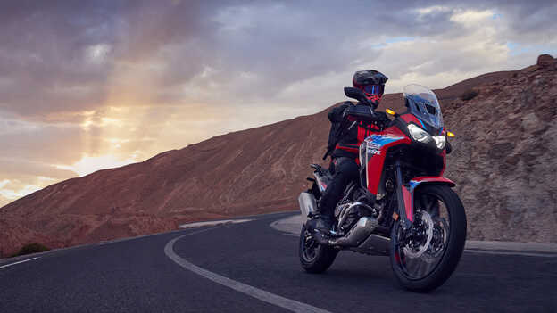 Africa Twin front three quarter with rider on road