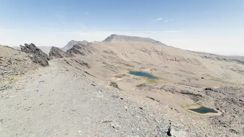 Scenic road under blue sky along Mediterranean sea coastline on French-Italian border.