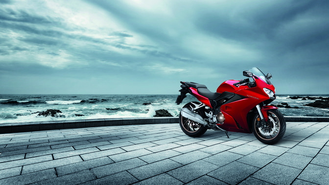 Honda VFR800F in front of a coastal location.