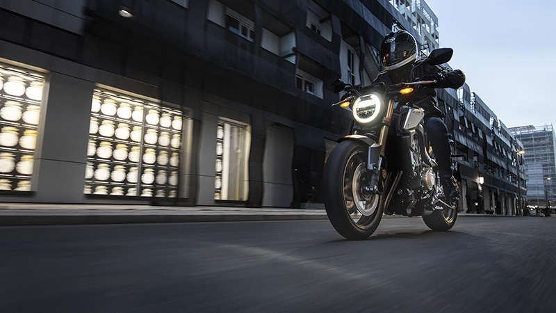 CB650R Neo Sports Café, 3-quarter left side with rider, in urban landscape