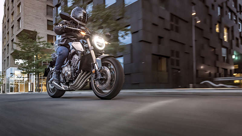 CB650R Neo Sports Café, 3-quarter right side with rider, in urban landscape