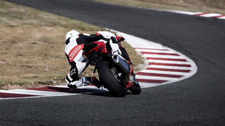 Rear facing Honda CBR1000RR Fireblade with rider on race track.