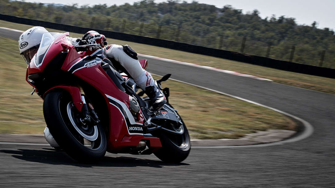 Front three-quarter facing Honda CBR1000RR on a track corner.
