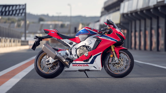 Front-three-quarter facing Honda Fireblades, race track shot.