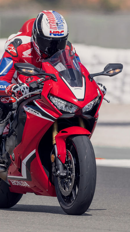 Front three-quarter facing Honda Fireblade on racetrack.