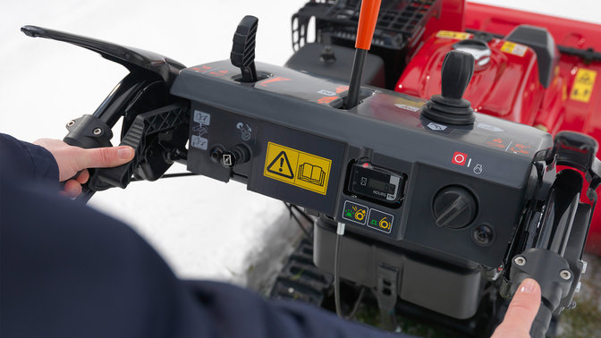 hands holding snowthrower handle