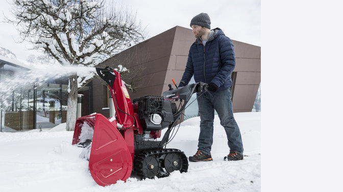 Snowthrower side facing, in use by model.