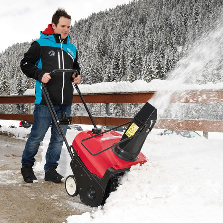 Snowthrower being used by model, snow location.