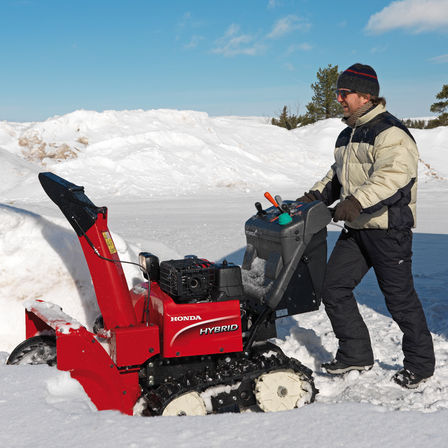 Snowthrower being used by model, snow location.