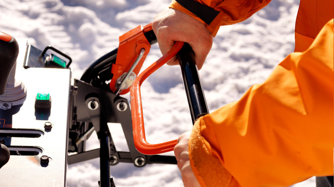 hands holding snowthrower handle